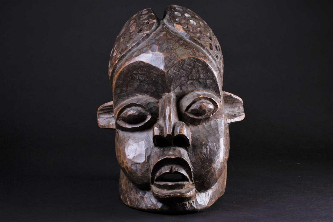 A Bamileke helmet mask, Cameroon, an elliptical opening: A Bamileke helmet mask, Cameroon, an elliptical opening to the crown of the elongated head, with pronounced eyes, nose and mouth, 34cmFootnote: The late Reverend Alan Dupuy