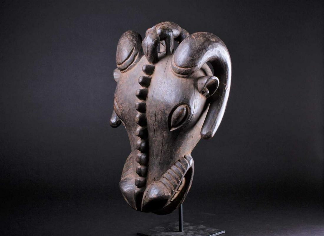 A Bamileke zoomorphic Buffalo mask, Cameroon, the eyes: A Bamileke zoomorphic Buffalo mask, Cameroon, the eyes and mouth with traces of kaolin, 45cm