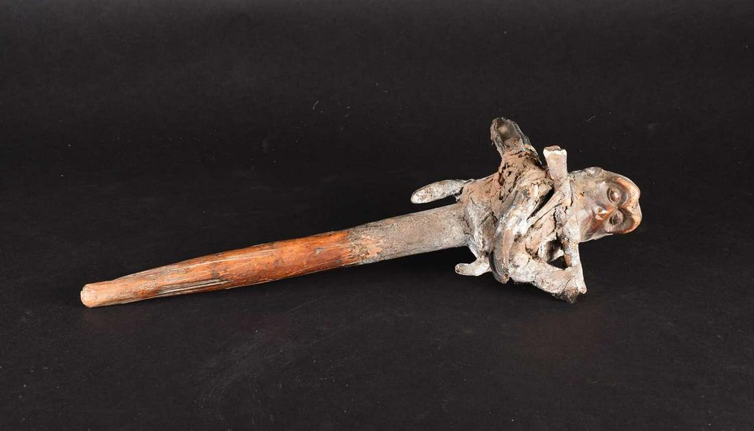 An African Witch Doctors medicine staff/fetish, carved: An African Witch Doctors medicine staff/fetish, carved as a monkeys head above a mixture of bones, seed pods, wood and clay, on a short shaft, 45.7cm Footnote: Formerly in the private collection of a 