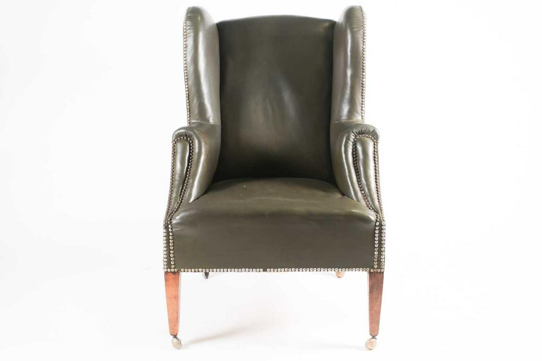 A late 19th century green leather upholstered wingback: A late 19th century green leather upholstered wingback armchair with studded finish, 103 cm high x 65 cm wide, the seat 43 cm high x 51 cm deep.