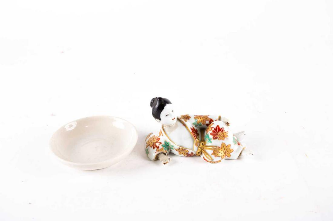 A Chinese blanc de chine small dish, 17th/18th century,: A Chinese blanc de chine small dish, 17th/18th century, 9.3cm diameter; and a late 19th century Arita reclining lady, her kimono with maple leaves,11.5cm