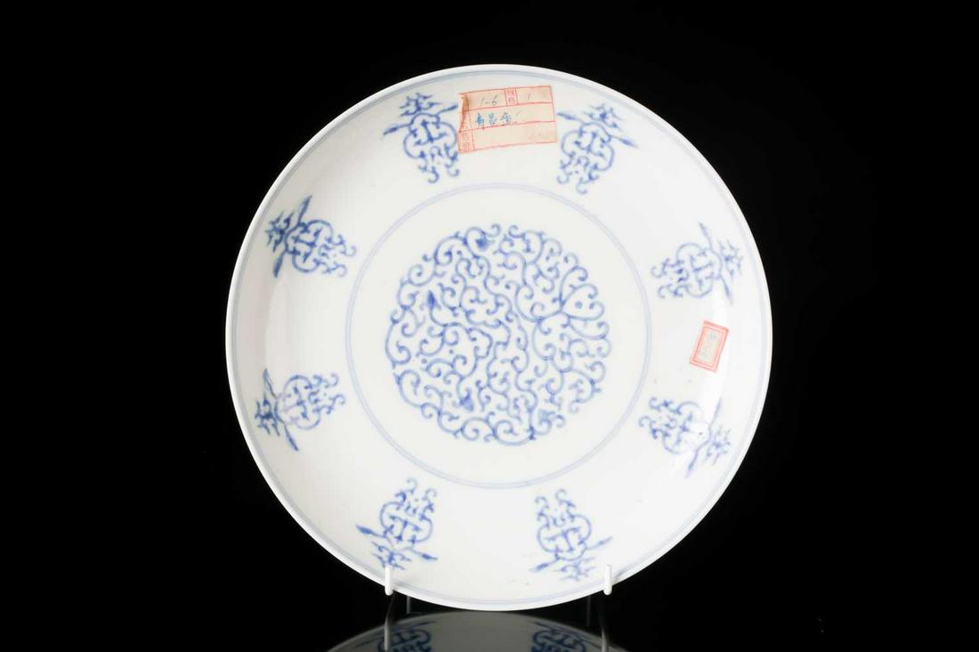 A Chinese, Qing dynasty blue and white porcelain,: A Chinese, Qing dynasty blue and white porcelain, shallow circular dish painted with a central panel of ruyi and scrollwork within border of open lantern-shaped emblems. Bearing a Six character mark f