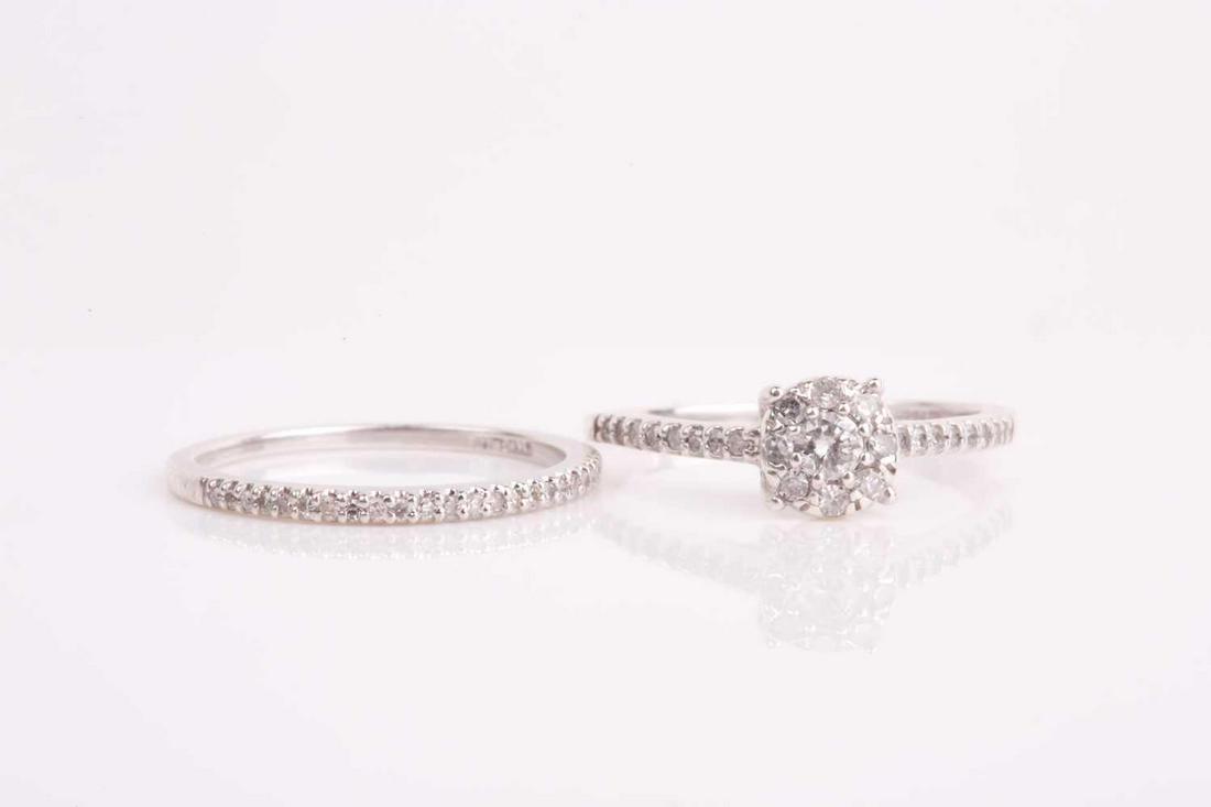 A silver and diamond cluster engagement style ring, set (1 of 4)