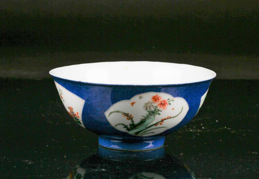 A Chinese, Qing dynasty, export porcelain circular bowl: A Chinese, Qing dynasty, export porcelain circular bowl with fan-shaped landscape and floral panels in colours on a powder blue ground. Bearing vacant double ring mark to base. Probably 19th century.