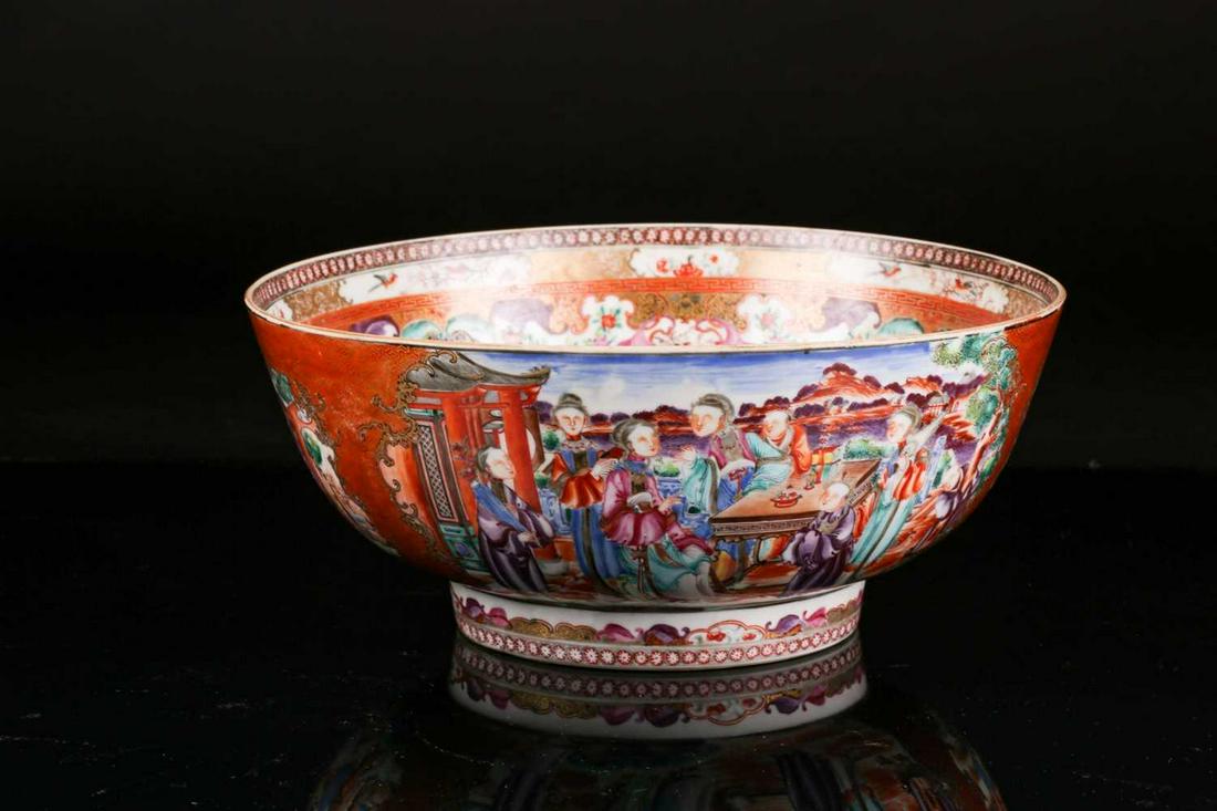 A Chinese Qianlong, famile rose, circular, porcelain: A Chinese Qianlong, famile rose, circular, porcelain punch bowl. Painted with vignettes of courtly figures dogs and fighting cocks in open pavilions within "Tau" borders. 24.5 cm diameter x 13 cm high