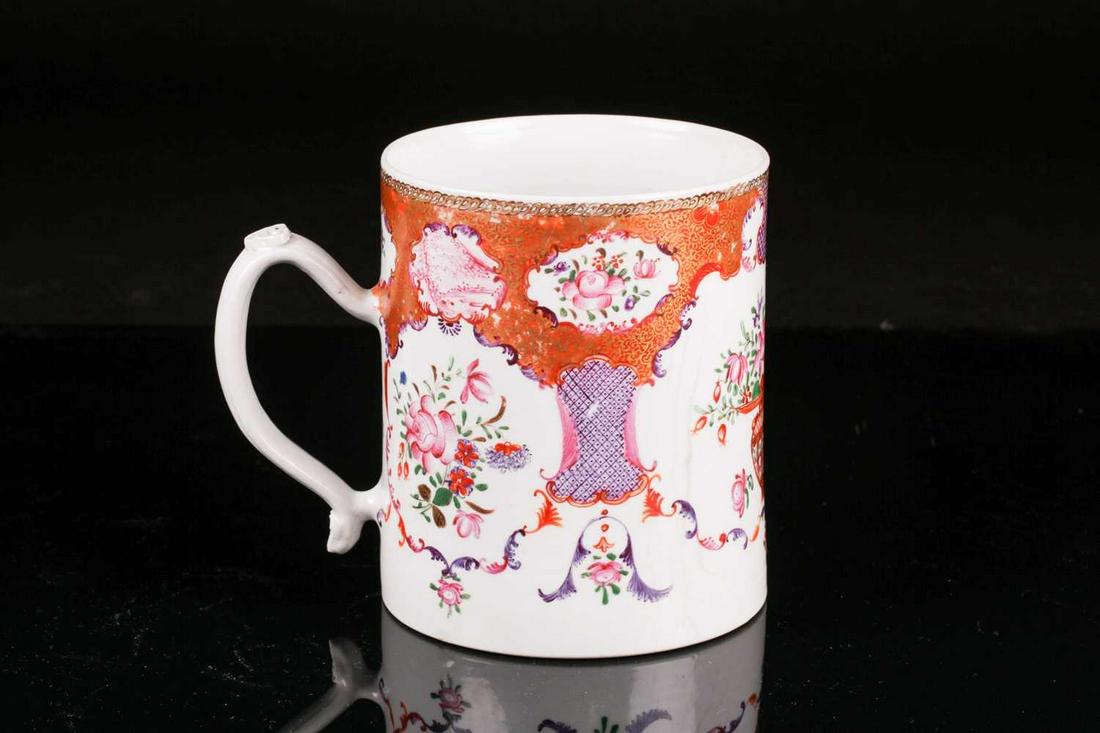 A Chinese Qianlong, famille rose porcelain ale tankard.: A Chinese Qianlong, famille rose porcelain ale tankard. Painted with a flowering censer and cut summer blooms within karakusa and diaper borders. Fitted with a molded loop handle with ruyi thumbpiece 