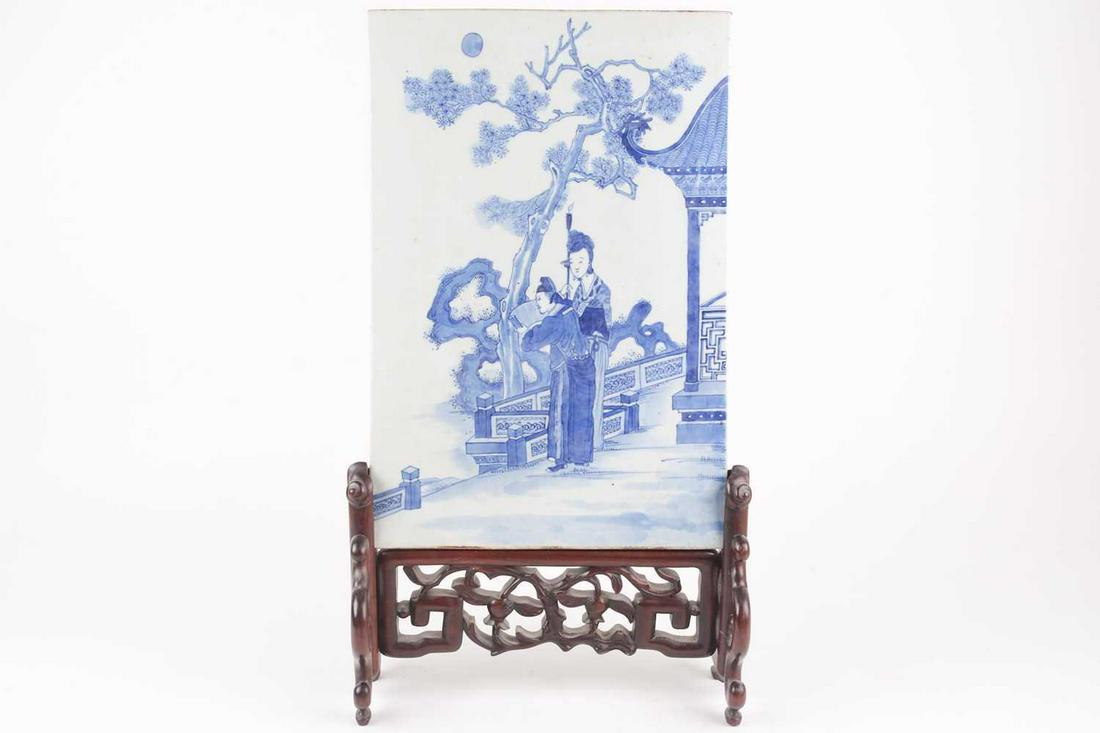 A Chinese blue & white porcelain table screen, Qing,: A Chinese blue & white porcelain table screen, Qing, 19th century, of rectangular form, painted with a scholar reading a scroll under moonlight, whilst his female attendant holds a burning candle, bef