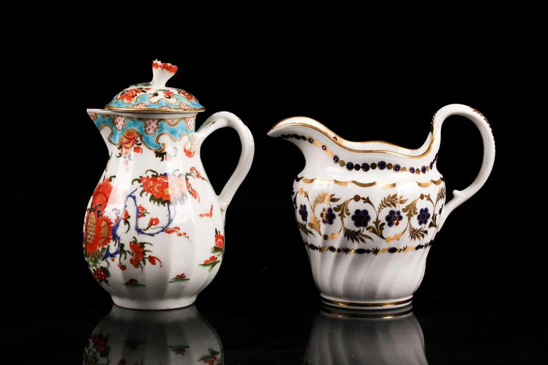 An 18th century,(first period) Worcester porcelain: An 18th century,(first period) Worcester porcelain fluted cream jug and cover, painted with the "Jabberwocky" pattern. With flower finial and entwined vine handle. Bearing an underglaze blue fretted s