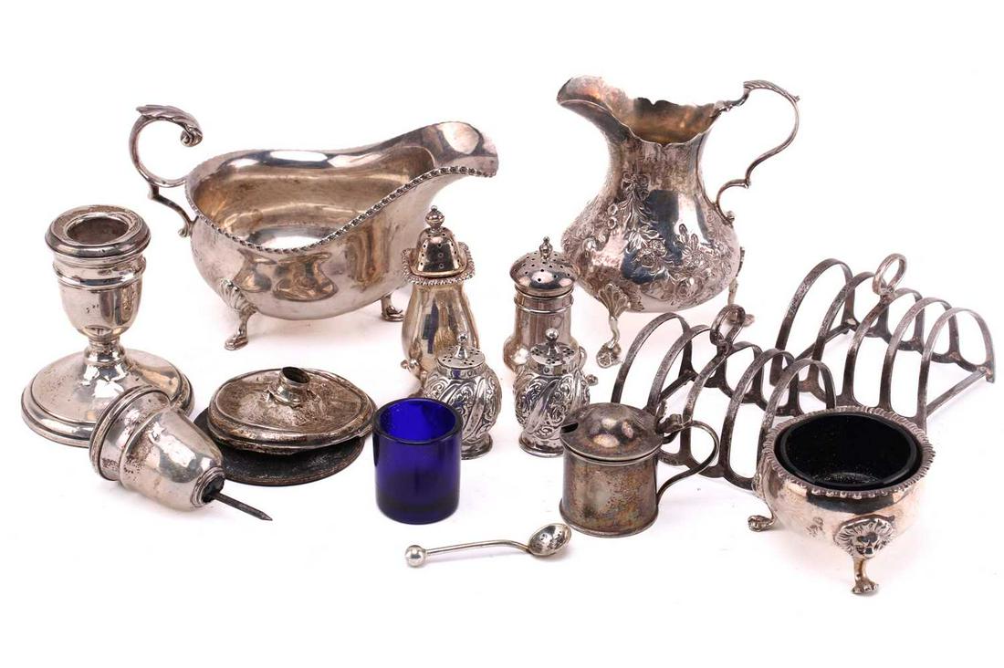 A Victorian silver cream jug, low-bellied form on three pad feet, repouss‚ decoration throughout and: A Victorian silver cream jug, low-bellied form on three pad feet, repouss‚ decoration throughout and a central monogram, leaf-capped double scroll handle, London 1866 by Thomas Smily; an Irish silve