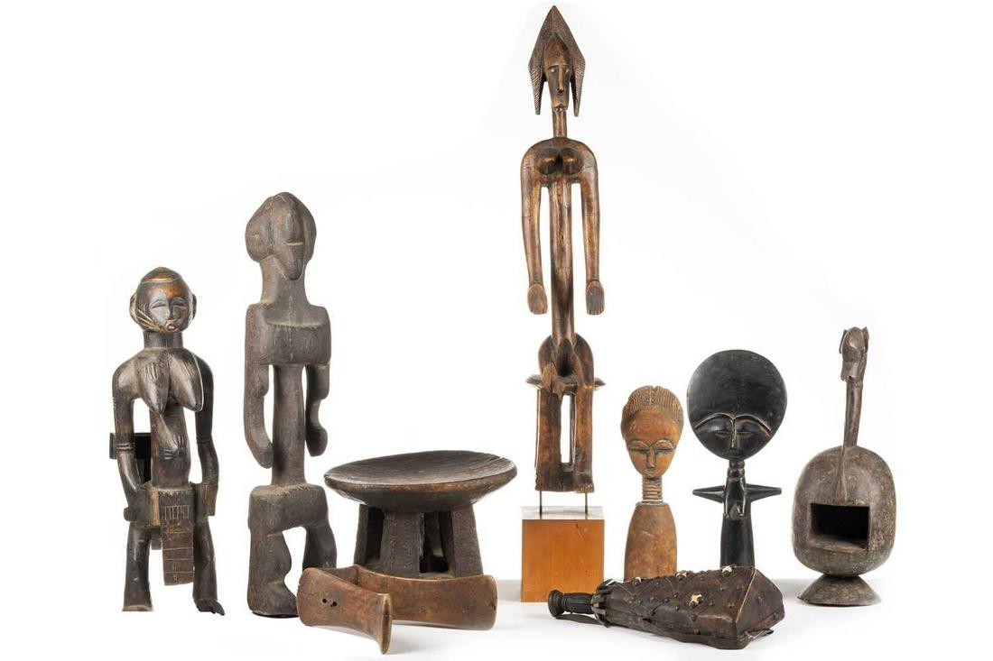 A collection of African ethnographica, comprising a Dogon seated female figure, 60.5cm (excluding (1 of 10)