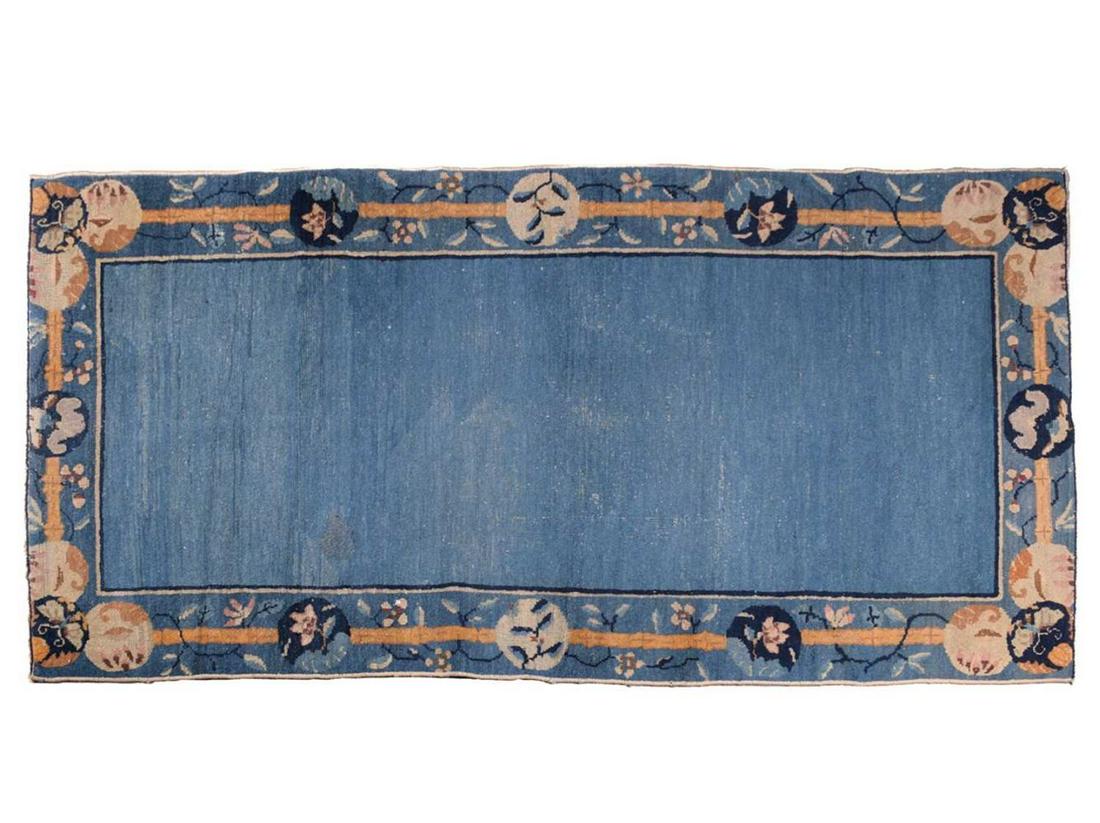 A Chinese Peking blue ground rug, late Qing, within borders of bamboo and butterflies,169 cm x 93 (1 of 7)