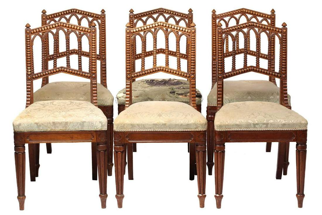 A set of six William IV oak Gothic revival side chairs possibly by Gillows of Lancaster the shallow: A set of six William IV oak Gothic revival side chairs possibly by Gillows of Lancaster the shallow lancet arched backs with bobbin-turned arcade splat above split can panel seats and later stuff over