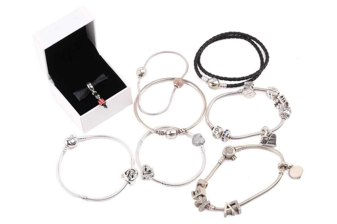 A collection of jewellery including five Pandora bracelets and charm bracelets in white metal, a: A collection of jewellery including five Pandora bracelets and charm bracelets in white metal, a Pandora bangle in white metal, a woven Pandora bracelet with white metal clasp, and a charm of a Royal