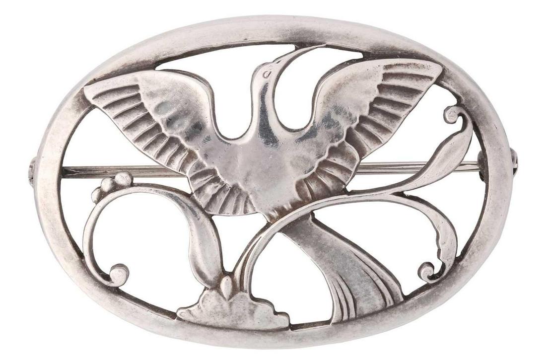 Georg Jensen - a Bird of Paradise openwork brooch, depicting a bird spreading wings amongst the (1 of 3)