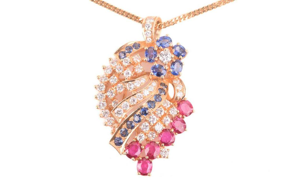 A diamond, ruby and sapphire spray pendant on chain; the stylised spray comprising a six stone: A diamond, ruby and sapphire spray pendant on chain; the stylised spray comprising a six stone sapphire and diamond cluster, above textured bands of round brilliant cut diamonds, circular cut sapphire