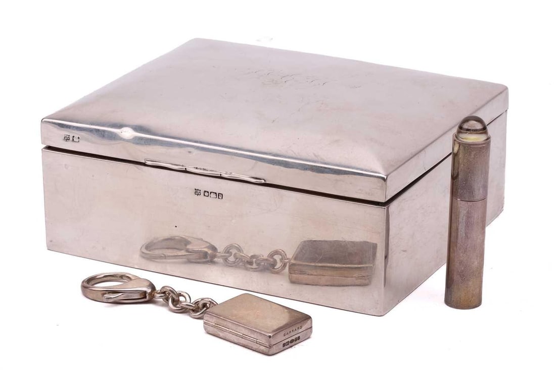 Garrard; a silver handbag sized atomiser and a rectangular pill box on key ring fob, both Garrard,: Garrard; a silver handbag sized atomiser and a rectangular pill box on key ring fob, both Garrard, London 2003; a silver cigarette box, rounded rectangular with monogram engraved to cover, Sheffield 1