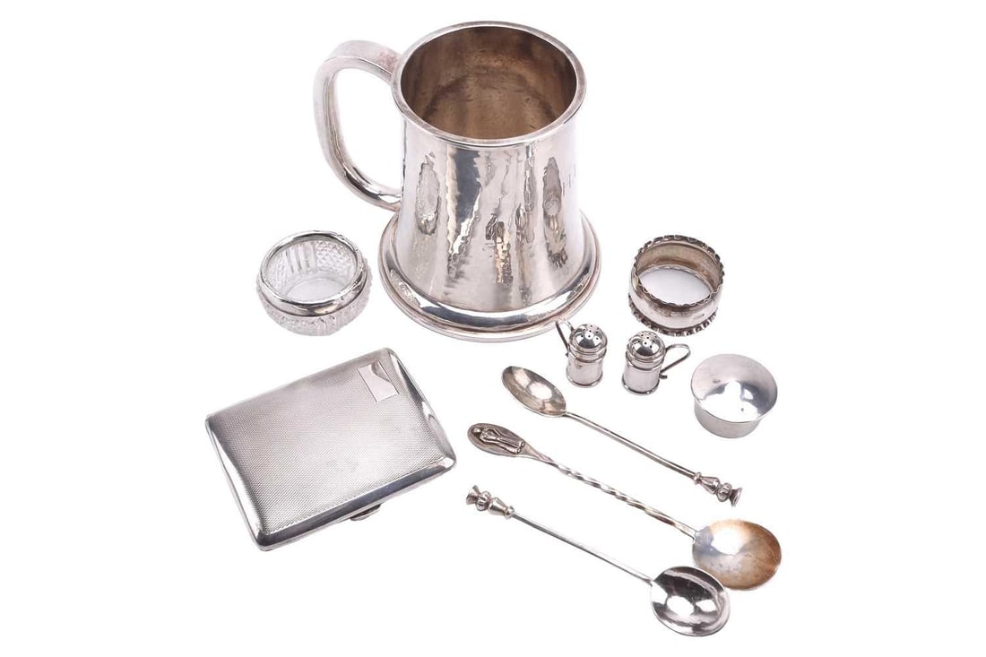 A white metal tankard, spot hammered flared cylindrical with C scroll handle and monogram engraved: A white metal tankard, spot hammered flared cylindrical with C scroll handle and monogram engraved to centre; together with a small circular pill box, Birmingham 1907 and a small quantity of other sil