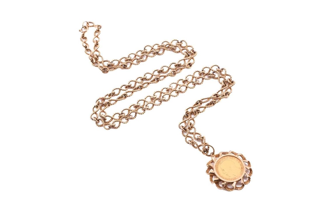 A George V half sovereign pendant on chain, dated 1911, in 9ct yellow gold scrolled mount, to an: A George V half sovereign pendant on chain, dated 1911, in 9ct yellow gold scrolled mount, to an associated figure-of-eight chain, London hallmarked '375', 1975, overall length 78.0 cm, total weight o