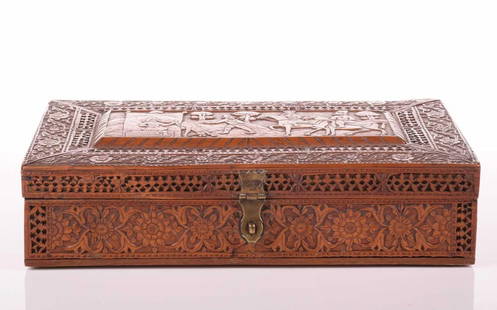 A large finely carved Persian rectangular sandalwood table box, Qajar Dynasty, 19th century, the: A large finely carved Persian rectangular sandalwood table box, Qajar Dynasty, 19th century, the cover carved with a royal hunting party within a meandering floral border, 34 cm long x 20 cm wide x 8.