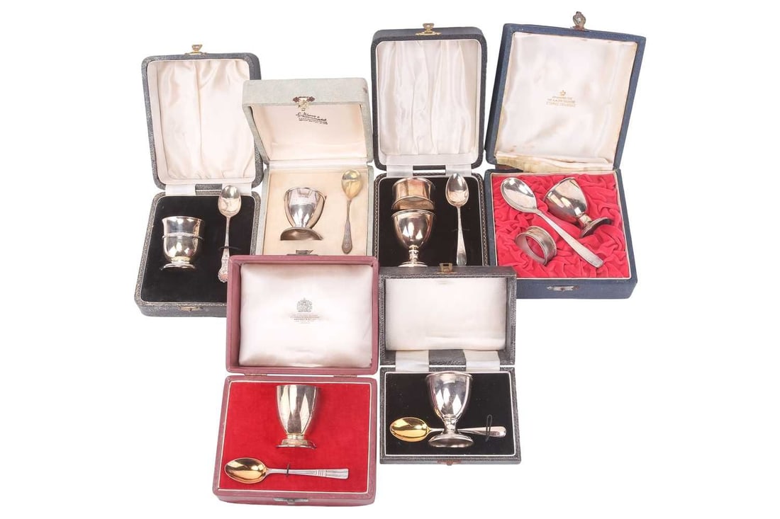 Asprey; a cased silver egg cup and spoon, London 1977, a cased silver egg cup and spoon, Birmingham: Asprey; a cased silver egg cup and spoon, London 1977, a cased silver egg cup and spoon, Birmingham 1957 by S Lesser & Sons Ltd; another set including a napkin ring, Birmingham 1954 by S Lesser & Sons