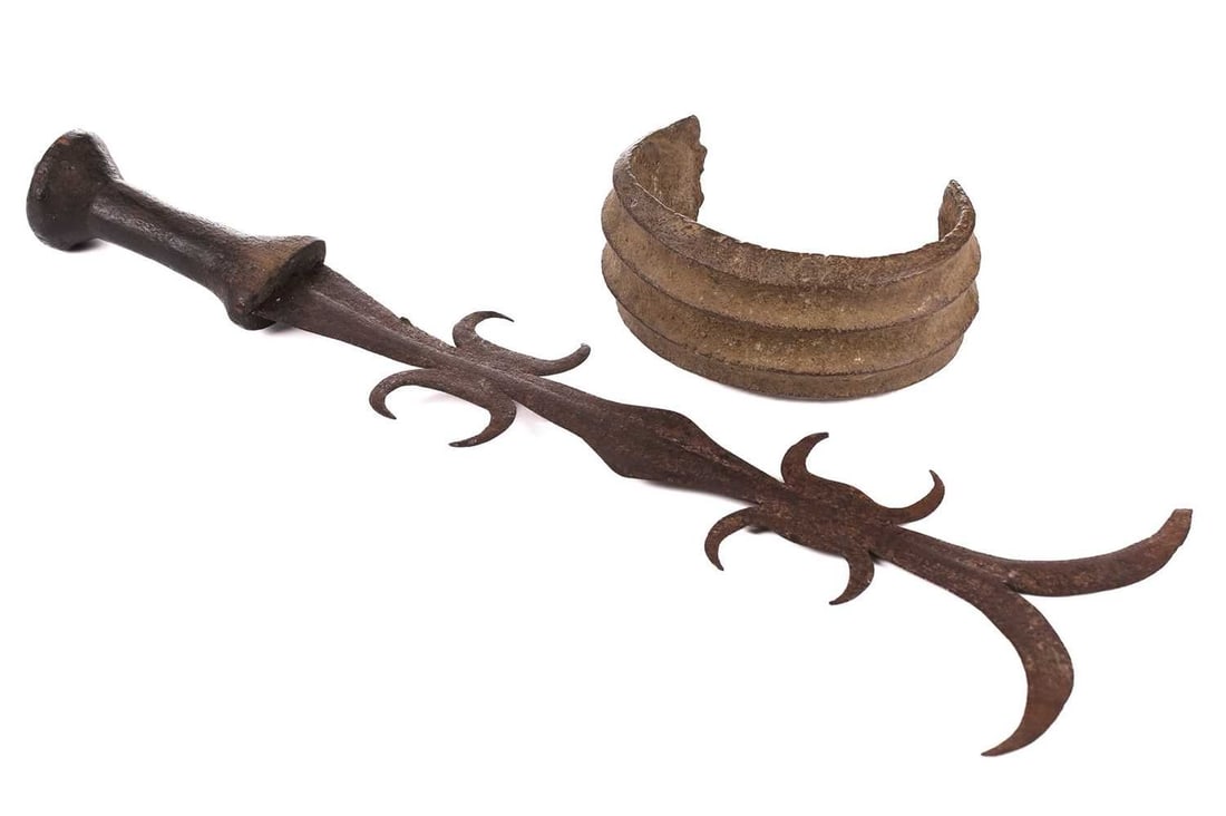 A bronze Congo wedding dowry anklet, 15 cm wide, together with a Mongo tribal chief's ngulu: A bronze Congo wedding dowry anklet, 15 cm wide, together with a Mongo tribal chief's ngulu (executioner's sword) thought to be 17th/18th century, 47 cm long in total.
