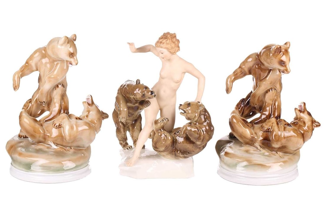 A Hutschenreuther porcelain figure group of a female nude playing with a pair of brown bears, signed: A Hutschenreuther porcelain figure group of a female nude playing with a pair of brown bears, signed Karl Tutter, 30 cm high, together with two Zsolnay porcelain figures of bears in combat, one hand-p