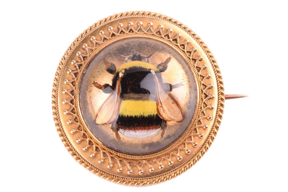 An Essex crystal bee brooch, containing a round rock crystal cabochon with reverse intaglio (1 of 3)