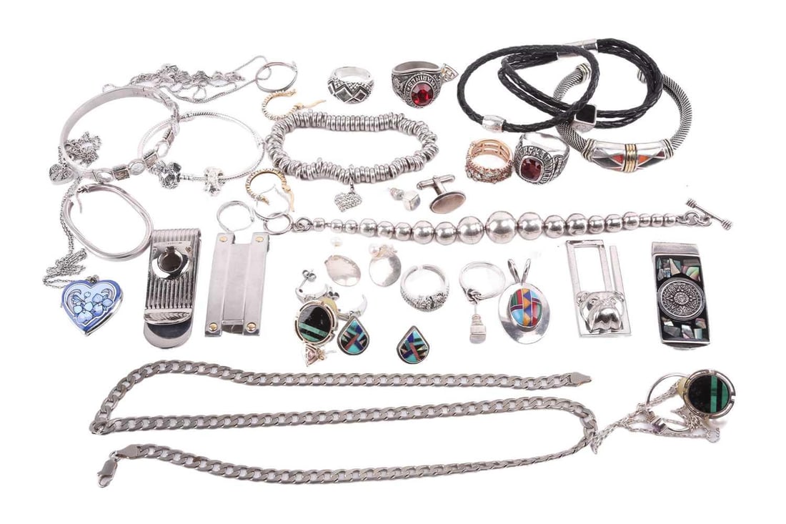 An assortment of jewellery, comprising 4 money clips, 8 bracelets, 4 necklaces, 8 rings, 8 sets of: An assortment of jewellery, comprising 4 money clips, 8 bracelets, 4 necklaces, 8 rings, 8 sets of earrings, one single earring, one cufflink and one pendant. Some items are stamped '925'. Total weigh