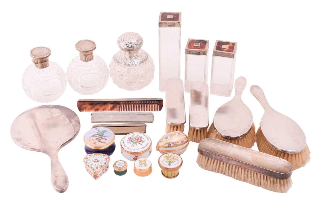 A silver 1950s dressing table set with additional perfume bottles and pill boxes comprising a hand: A silver 1950s dressing table set with additional perfume bottles and pill boxes comprising a hand mirror with engine-turned patterns, two matching hairbrushes, three clothes brushes, two tortoiseshel