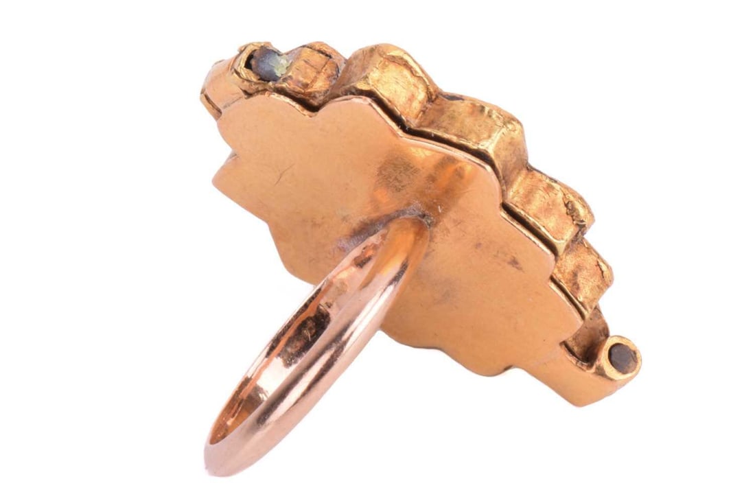 An Indian gem-set panel ring, centred with a green paste cabochon and encircled by a frame of (1 of 3)