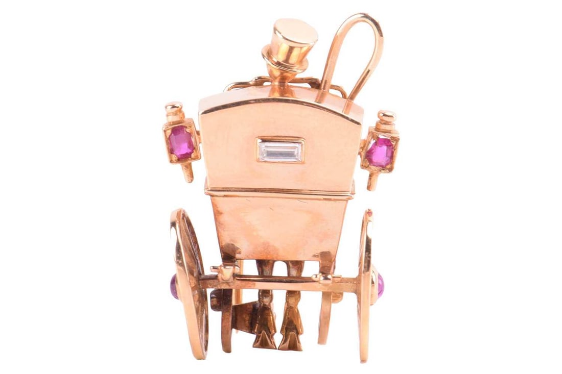 A Mellerio dits Meller ruby and diamond carriage brooch, French, circa 1950s, modelled as a: A Mellerio dits Meller ruby and diamond carriage brooch, French, circa 1950s, modelled as a departing horse-drawn carriage, set with a diamond for the rear window, cushion shape rubies to each lantern