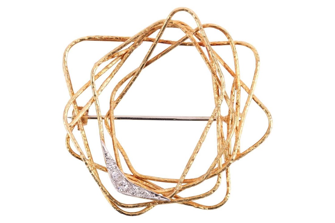Andrew Grima - an 18ct gold and diamond brooch; comprising overlaid, textured wirework: Andrew Grima - an 18ct gold and diamond brooch; comprising overlaid, textured wirework quadrilaterals; one set with a crescent accentuated with five graduated round brilliant cut diamonds. Hallmarks f
