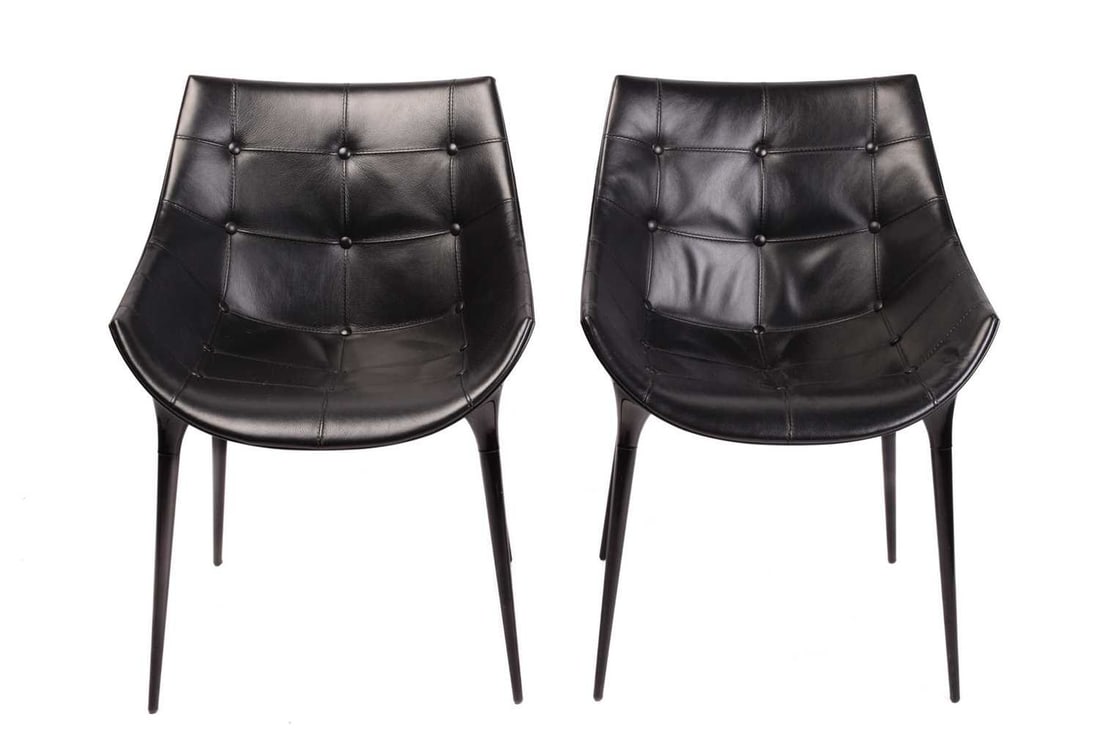 Philippe Starck for Cassina, a pair of 'Passion' 246 chairs, with injection moulded black plastic: Philippe Starck for Cassina, a pair of 'Passion' 246 chairs, with injection moulded black plastic shell and leather buttoned seats, raised on tapering black legs, 80 cm high x 55 cm wide.