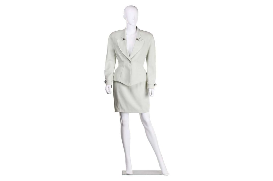 Thierry Mugler - a two-piece power suit in mint colour, circa 1980s, comprising a pencil skirt and: Thierry Mugler - a two-piece power suit in mint colour, circa 1980s, comprising a pencil skirt and matching blazer, with padded shoulders, side pockets and peplum waist detail, snap closure at front,
