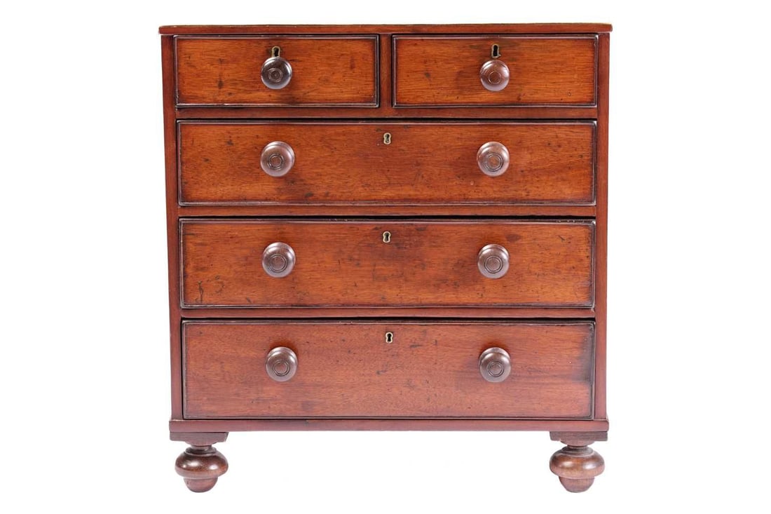 A nineteenth-century mahogany miniature chest of two short over three long drawers, terminating on (1 of 4)