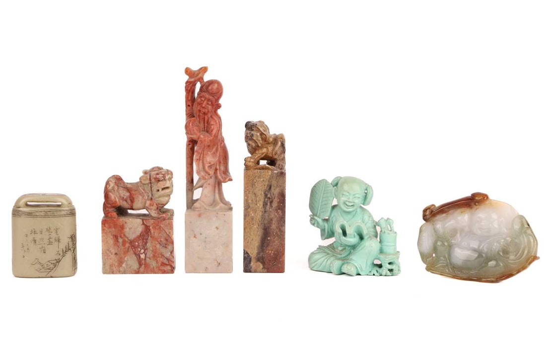 A Chinese mutton fat and green jade panel carved with a laughing Buddha, 6 cm long x 4.2 cm high, to: A Chinese mutton fat and green jade panel carved with a laughing Buddha, 6 cm long x 4.2 cm high, together with a Dog of Foo mounted soapstone chop seal, 8 cm high and a Chinese soapstone seal in the