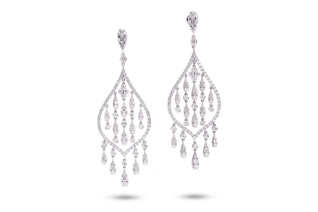 A pair of diamond set drop earrings, by Crivelli. The round brilliant cut diamonds weigh: A pair of diamond set drop earrings, by Crivelli. The round brilliant cut diamonds weigh approximately 7.30ct in total. Each pear-shaped ear pendant suspends five diamond set drops. The latch backs ar