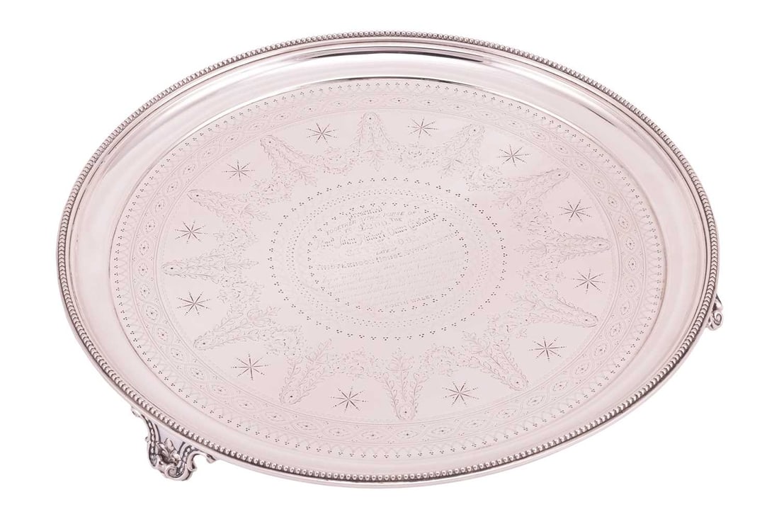 A Victorian silver presentation salver with engraved dedication, by Frederick Elkington, Birmingham: A Victorian silver presentation salver with engraved dedication, by Frederick Elkington, Birmingham 1874, of circular form with beaded edge, stippled with detailed floral swags and star motifs, raised