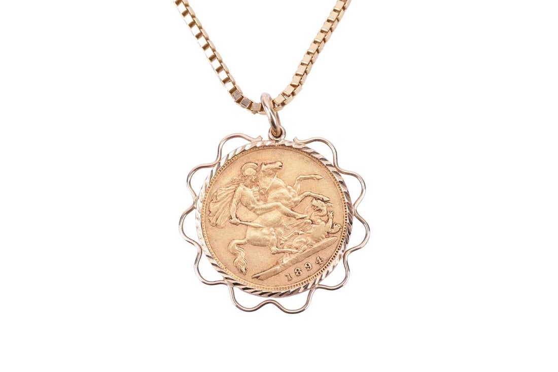 A gold half-sovereign pendant, in a yellow metal mount tested as 14ct gold, on a 9ct yellow gold box (1 of 3)