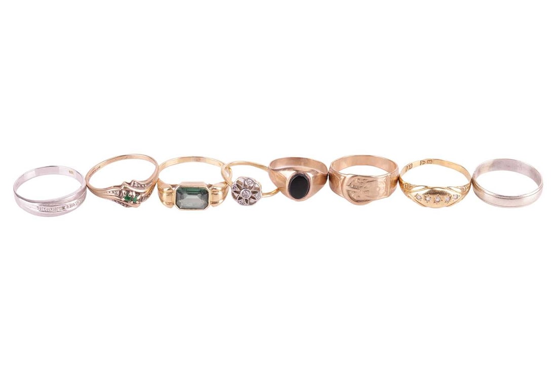 A collection of eight assorted rings, comprising a 9ct gold buckle ring, ring size N 1/2, an unmarke (1 of 3)