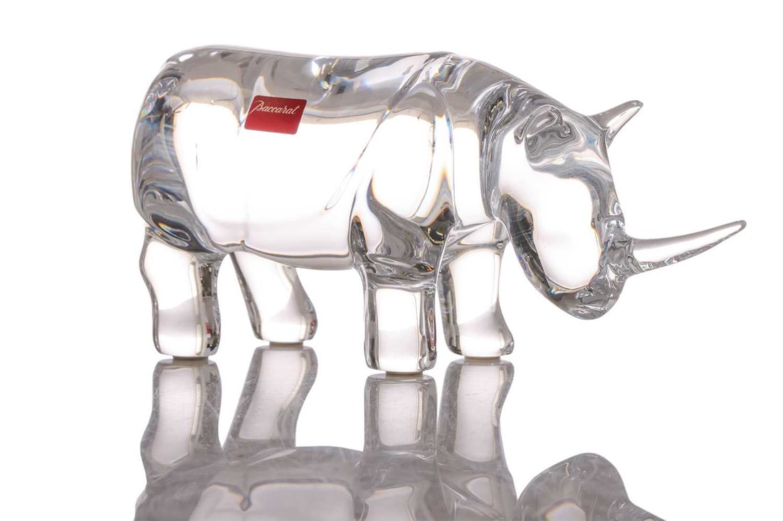 A Baccarat crystal glass figure of a rhinoceros, 8.5 cm x 18.5 cm, in original box.: A Baccarat crystal glass figure of a rhinoceros, 8.5 cm x 18.5 cm, in original box.