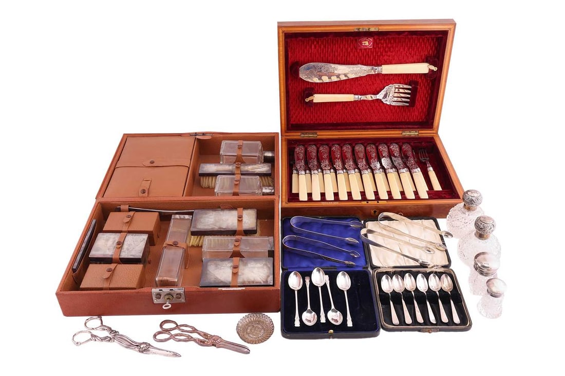 A gentleman's dressing case with silver mount brushes in a pig skin leather box; a boxed set of fish: A gentleman's dressing case with silver mount brushes in a pig skin leather box; a boxed set of fish knives and forks with silver collars and simulated ivory handles (missing two fish knives), a cased