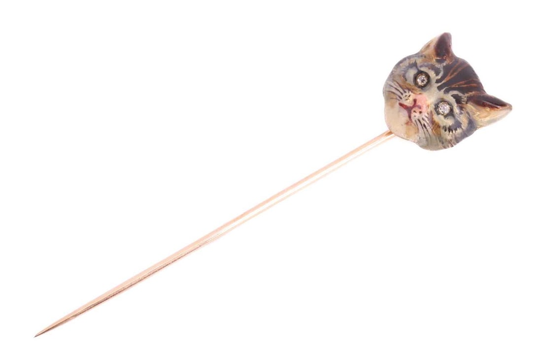An Edwardian cat head enamel stick pin, sculpted as a realistic head of a tabby cat, painted with (1 of 5)