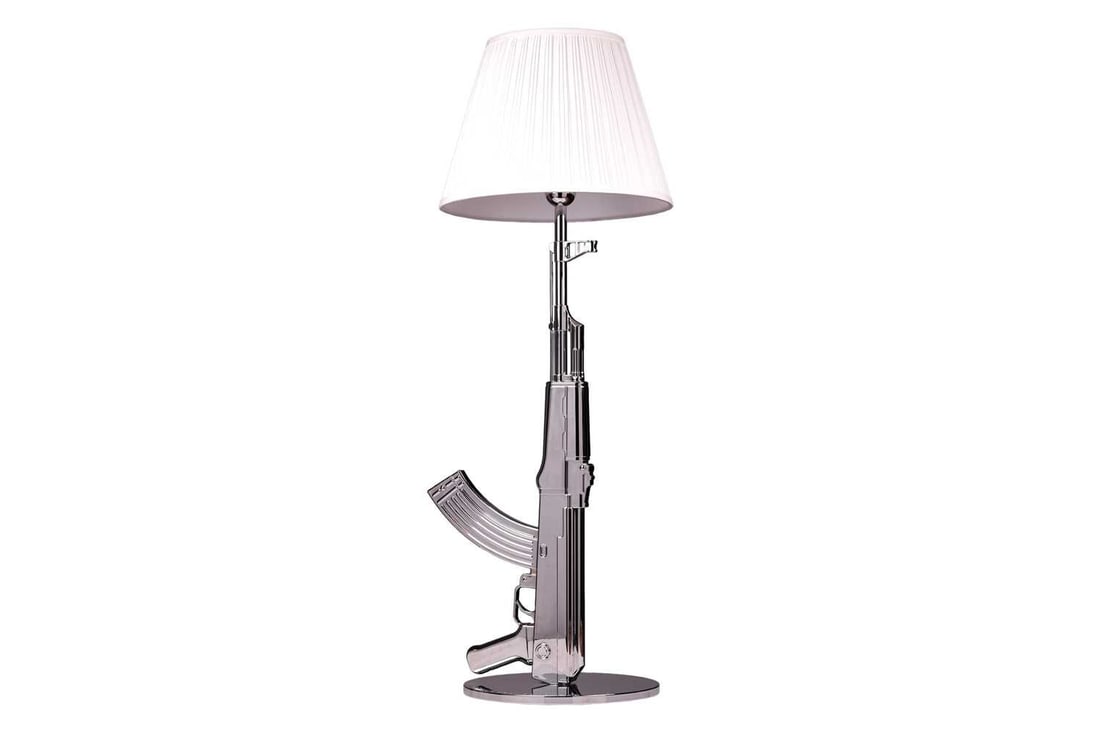 Philippe Starck for Flos, a large chrome metal table lamp modelled as an AK47, the circular base: Philippe Starck for Flos, a large chrome metal table lamp modelled as an AK47, the circular base impressed 'Happiness is a Hot Gun', 94 cm high to include the shade.