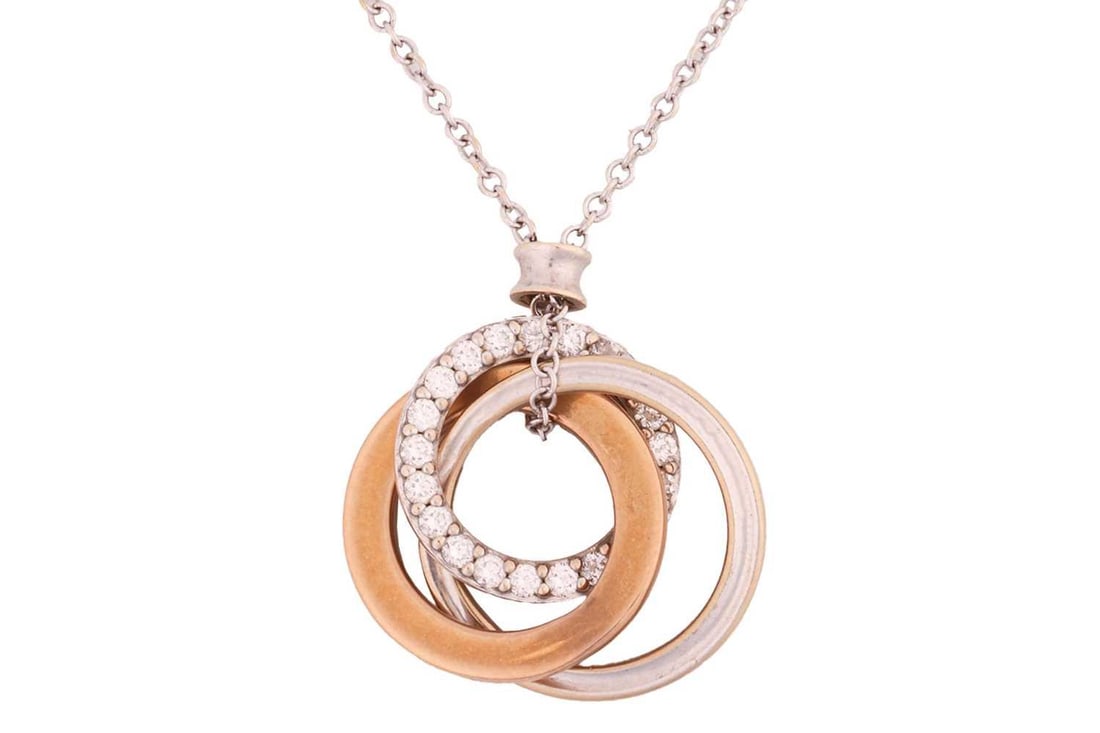 Tiffany & Co. - a diamond-set interlocking circles pendant on chain, three annulets forming a: Tiffany & Co. - a diamond-set interlocking circles pendant on chain, three annulets forming a Borromean ring in white, yellow and rose gold, pave-set with brilliant-cut diamonds, to a fine cable link
