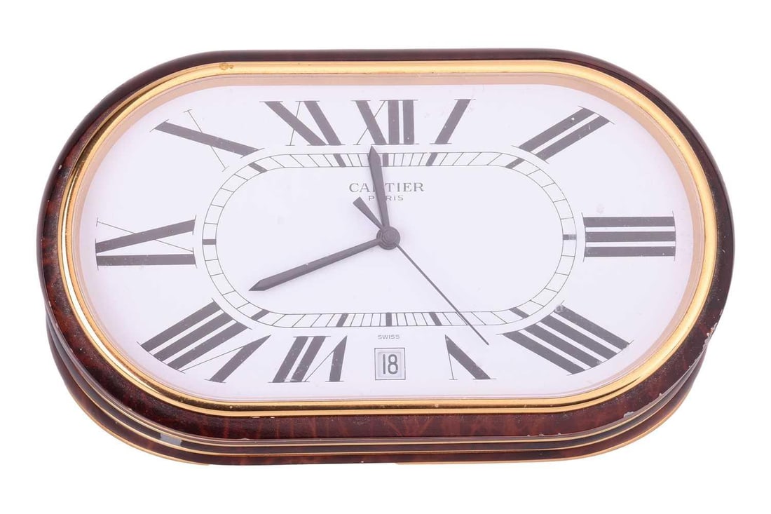 Cartier - A Faux Tortoise Shell Quartz Alarm Clock Model: 7531 Serial: 08320 Case Material: Enameled: Cartier - A Faux Tortoise Shell Quartz Alarm Clock Model: 7531 Serial: 08320 Case Material: Enameled Stainless Steel Case Diameter: 140x80mm Dial: White Signed Cartier Numerals: Roman Functions: Date