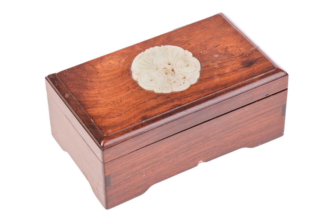A Chinese Huanghuali and jade rectangular wedding gift box, Qing Dynasty, 19th century, the push: A Chinese Huanghuali and jade rectangular wedding gift box, Qing Dynasty, 19th century, the push fitting top with thumb moulded edge and inset a jade disk bearing the emblems of cash and a butterfly (