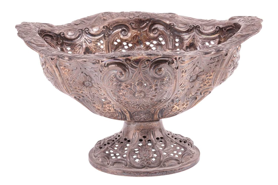 A Victorian pierced silver basket, by Charles Stuart Harris, London 1888, the pierced body with scro: A Victorian pierced silver basket, by Charles Stuart Harris, London 1888, the pierced body with scrollwork and embossed floral decoration, on a conforming spread pedestal, 26.0 cm wide, gross weight a