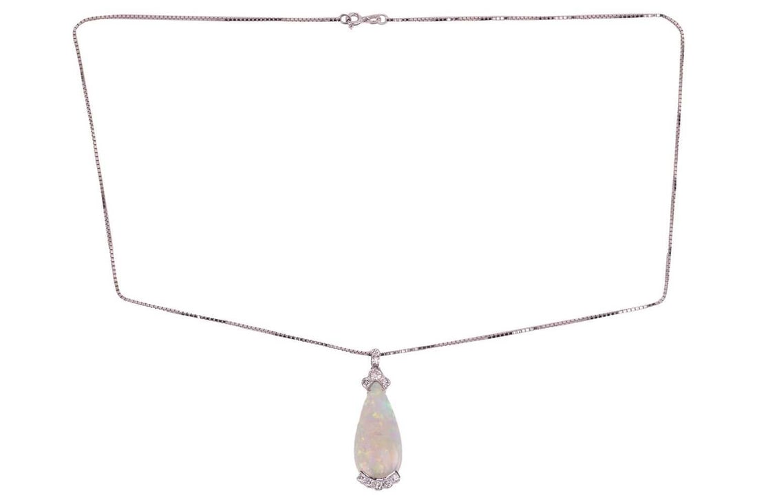 A large opal and diamond pendant on chain, featuring a teardrop-shaped precious opal cabochon,: A large opal and diamond pendant on chain, featuring a teardrop-shaped precious opal cabochon, displaying vibrant spectral play-of-colours on a light ground, approximately measuring 29.0 x 13.6 x 5.0