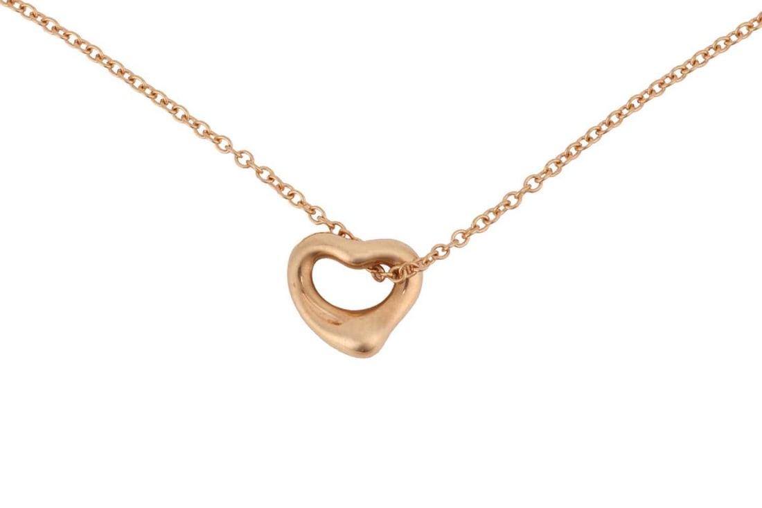 Tiffany & Co. an 18ct yellow gold open heart pendant on chain, by Elsa Peretti, small model, on a: Tiffany & Co. an 18ct yellow gold open heart pendant on chain, by Elsa Peretti, small model, on a fine cable link chain, Dutch convention marks, signed, pendant 7.0 mm, overall length 41.0 cm, 1.7 gra